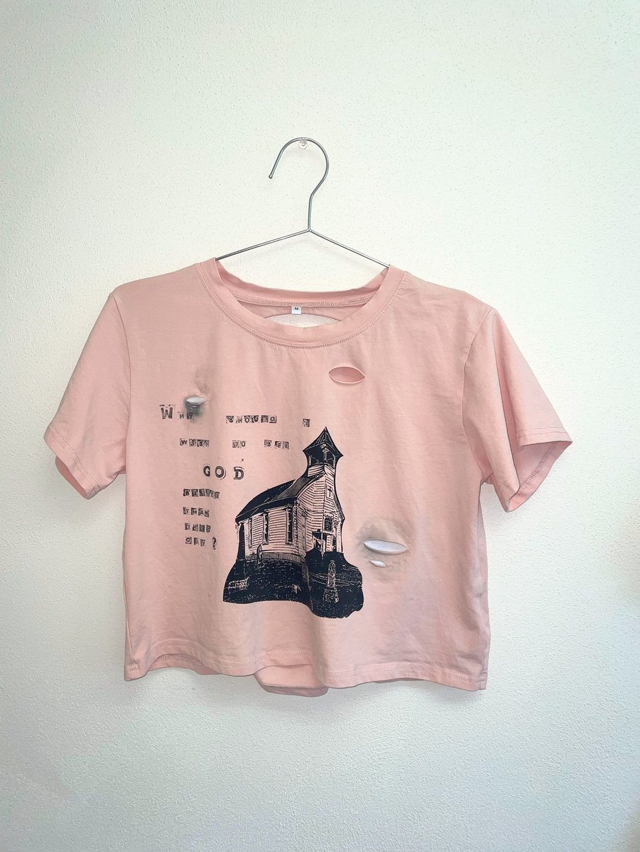 a pink crop top with an image of a church on it and text that reads "Why should I wish to see God better than this day?"