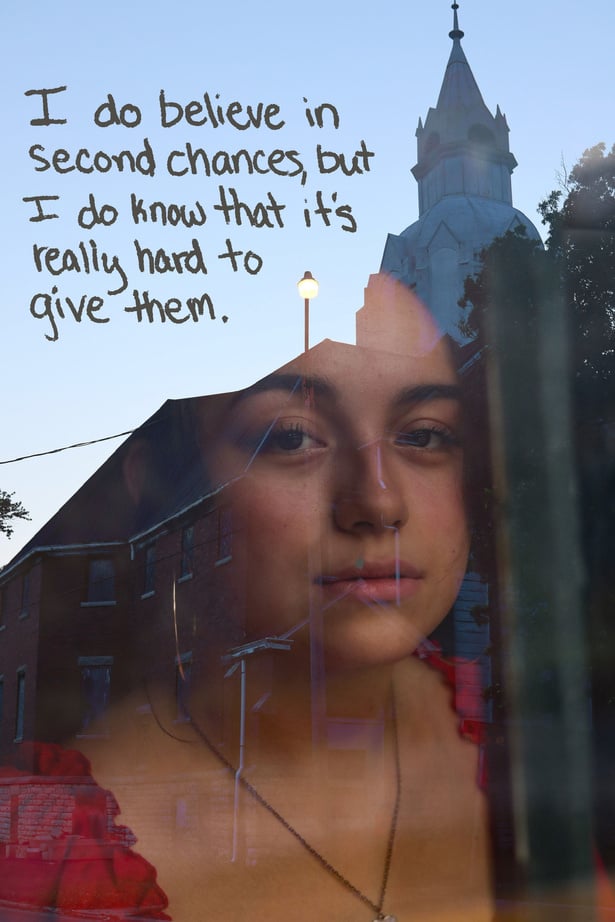 A person looking through a window with a church in the background and the text "I do believe in second chances, but I do know that it's really hard to give them."