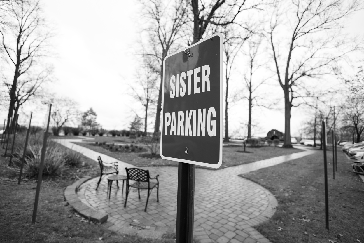 a black and white photo of a sign that says Sister Parking