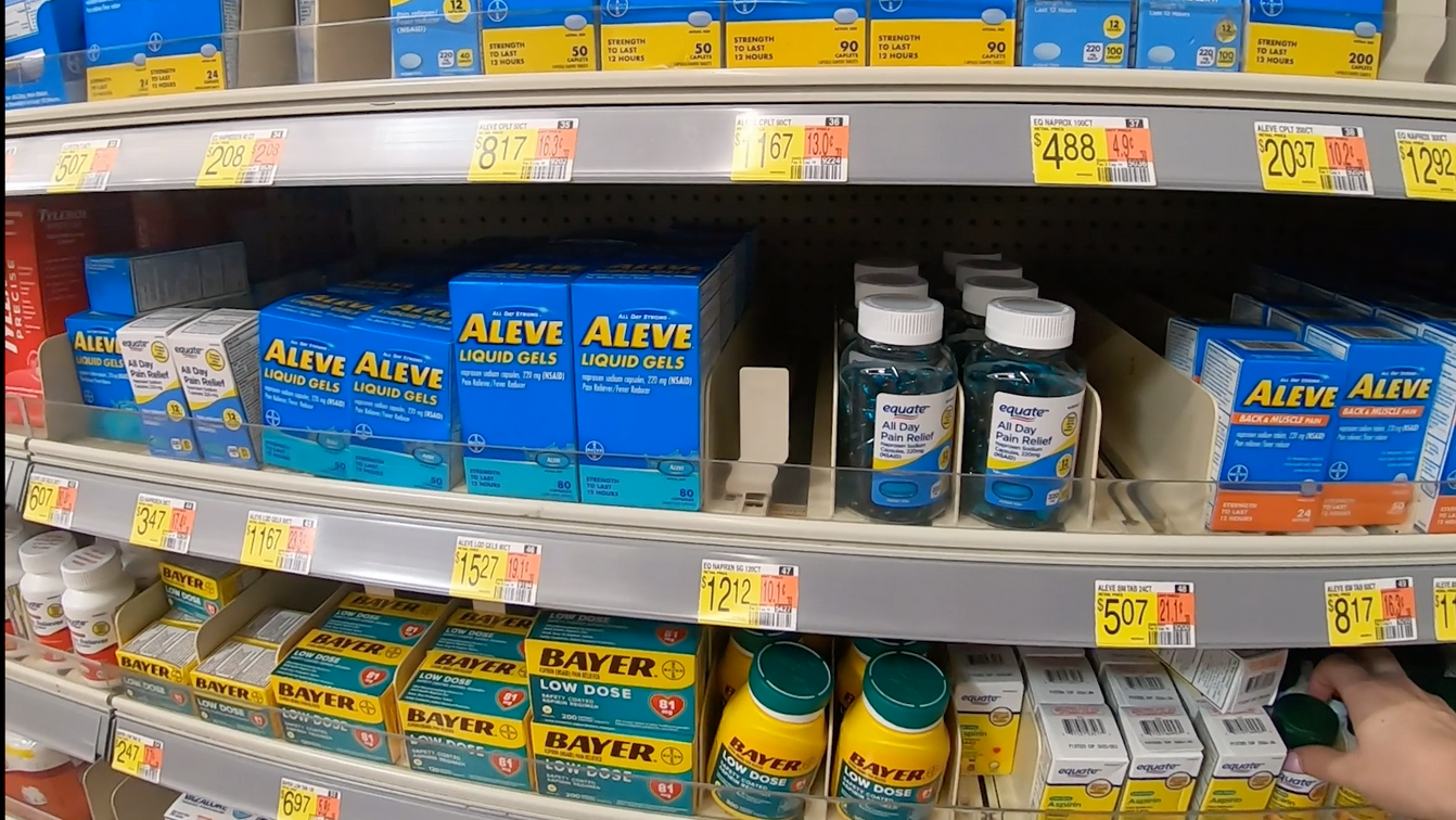 shelves filled with various types of pain relief medicine