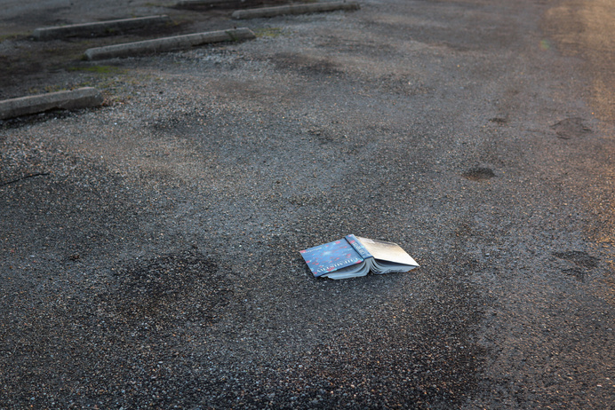 a chemistry textbook laying on the ground in a parking lot